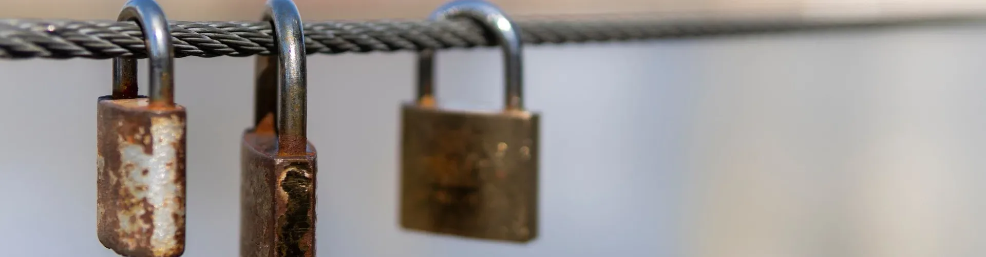 Three padlocks on a chain.