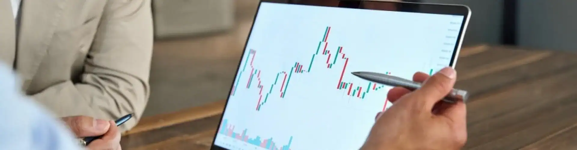 A man reviewing stock market movements on a laptop.